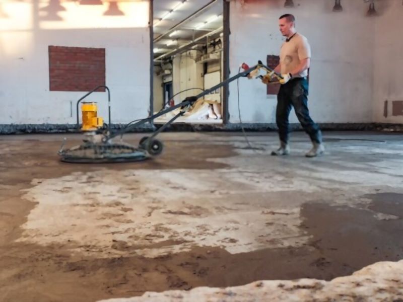 man flattening a floor