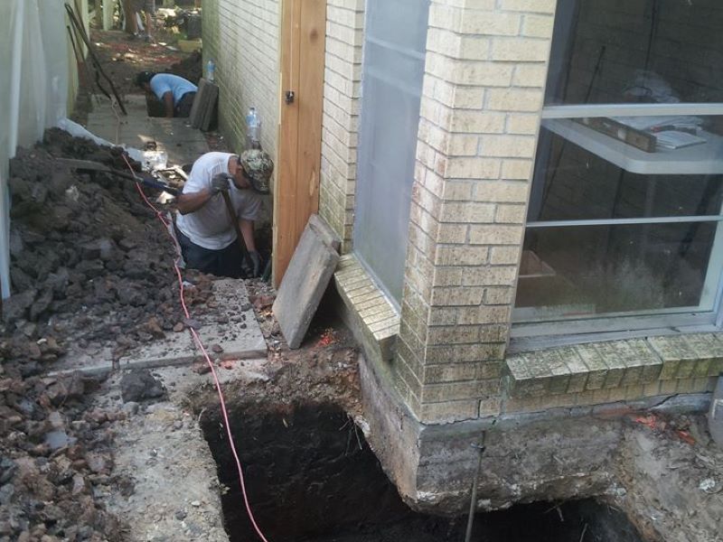 men fixing a concrete foundation